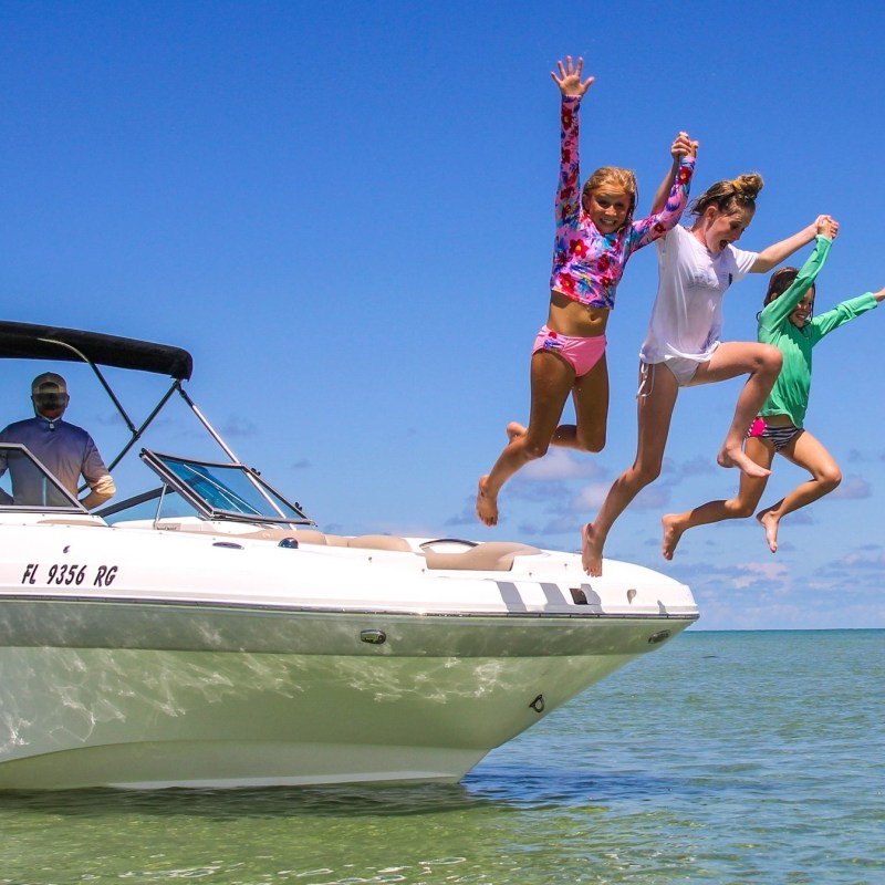 a person riding on the back of a boat in the water