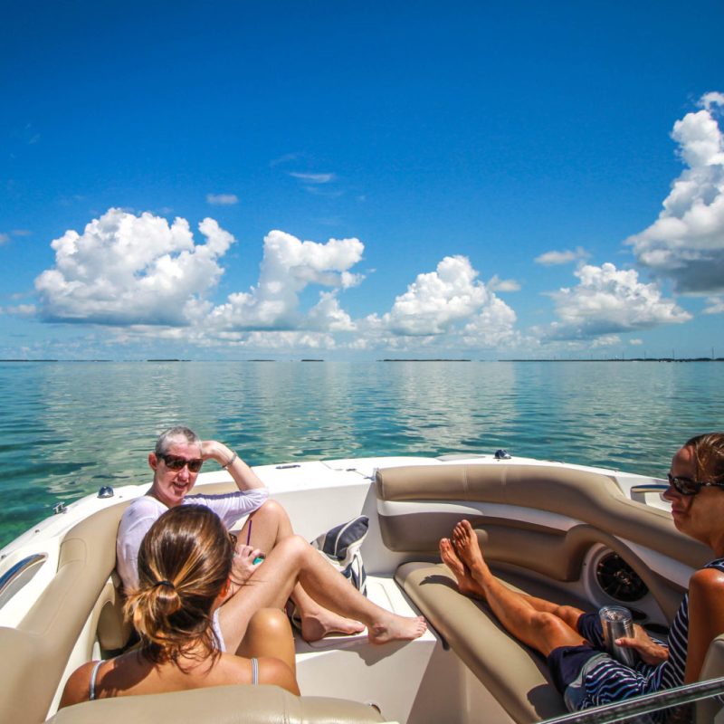 a woman sitting on a boat in a body of water